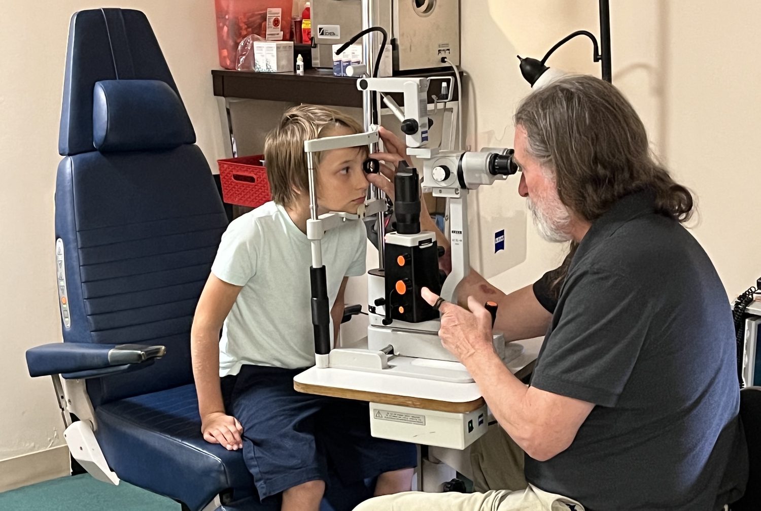 Dr. Carpenter carefully examining a patient's eye